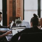 Employee - selective focus photography of people sits in front of table inside room