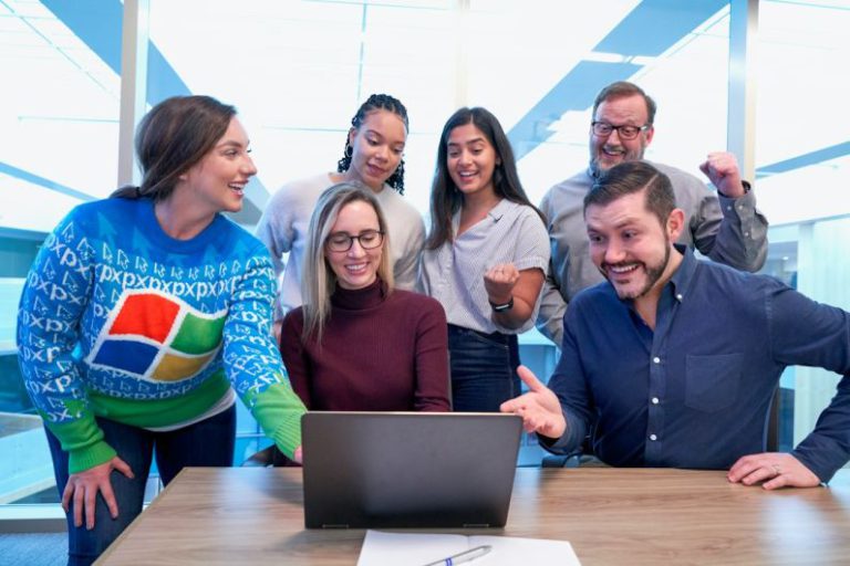 Employee - woman in maroon sweater using laptop