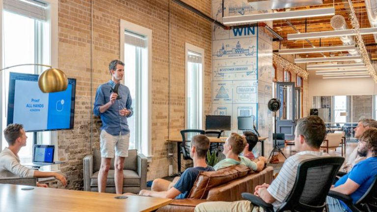 Leadership Business - man standing in front of group of men
