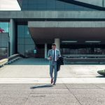 Leadership Business - man walking while holding black coat