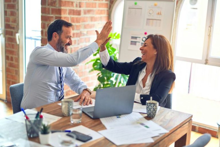 Team Business - man in white dress shirt sitting beside woman in black long sleeve shirt