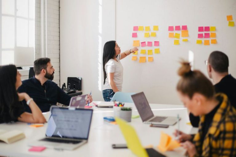 Marketing - woman placing sticky notes on wall