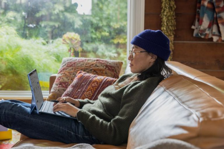 Business - a person sitting at a table using a laptop