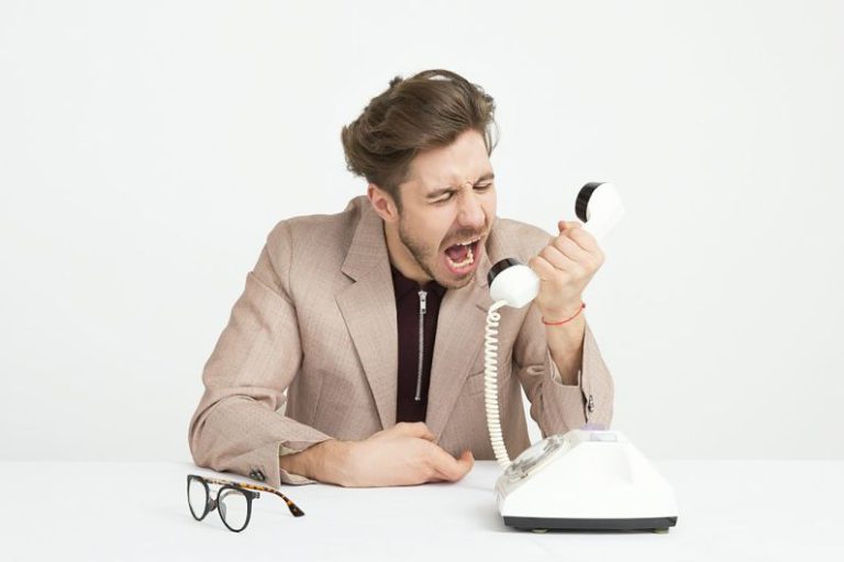 Communication - man holding telephone screaming