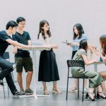 Communication - two men and four women meeting in office