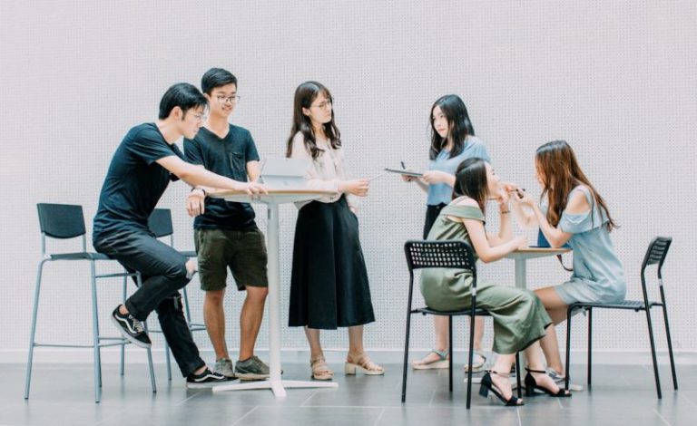 Communication - two men and four women meeting in office