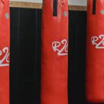 Supply Chains - Interior of boxing gym with heavy punching bags hanging on chains for workout