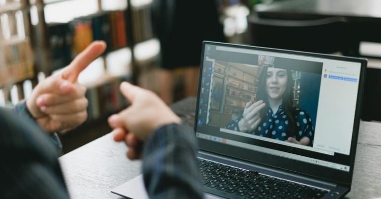 Nonverbal - Young lady learning sign language during online lesson with female tutor