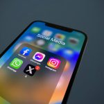 Rebrand - a close up of a cell phone with social media icons
