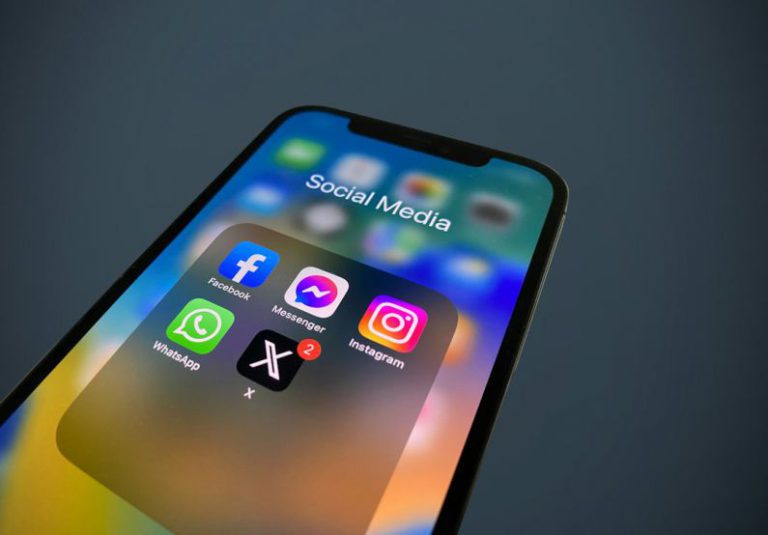 Rebrand - a close up of a cell phone with social media icons