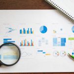 Business Finances - Overhead Shot of a Paper with Graphs and Charts