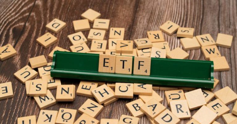 Asset Allocation - The word etf on a wooden board with scrabble tiles