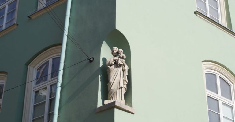 Niche Markets - White Statue of a Man on a Window