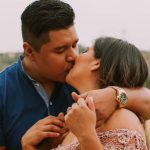 CRM - Latin American husband and wife kissing in field