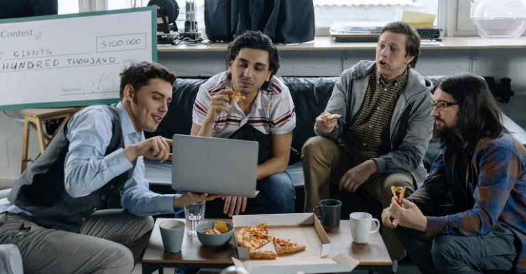 Start-up - Start-Up Team Discussing a Project over a Pizza