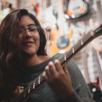 Talent - Shallow Focus Photo Of Woman Playing Guitar
