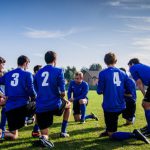Players - Group of Sports Player Kneeling on Field