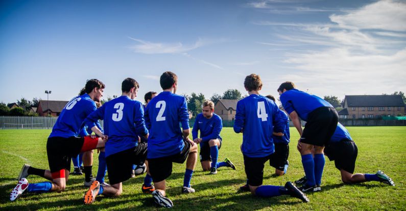 Players - Group of Sports Player Kneeling on Field