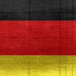 Global Reach - Grungy background designed as flag of Germany on shabby wooden board with measure scale