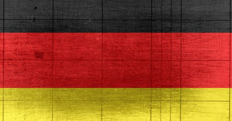Global Reach - Grungy background designed as flag of Germany on shabby wooden board with measure scale