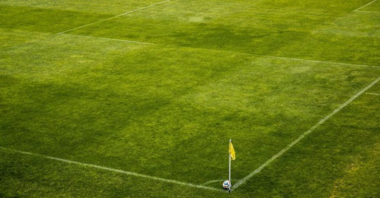 Pitch - White and Black Soccer Ball on Side of Green Grass Field during Daytime