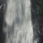 Satisfaction - Photo of Man Sitting Near Waterfalls