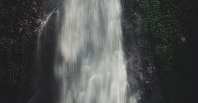 Satisfaction - Photo of Man Sitting Near Waterfalls