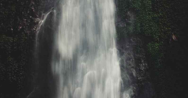 Satisfaction - Photo of Man Sitting Near Waterfalls