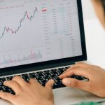 IPOs - Person Using Macbook Pro on White Table