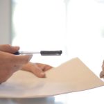 Policies - Crop businessman giving contract to woman to sign